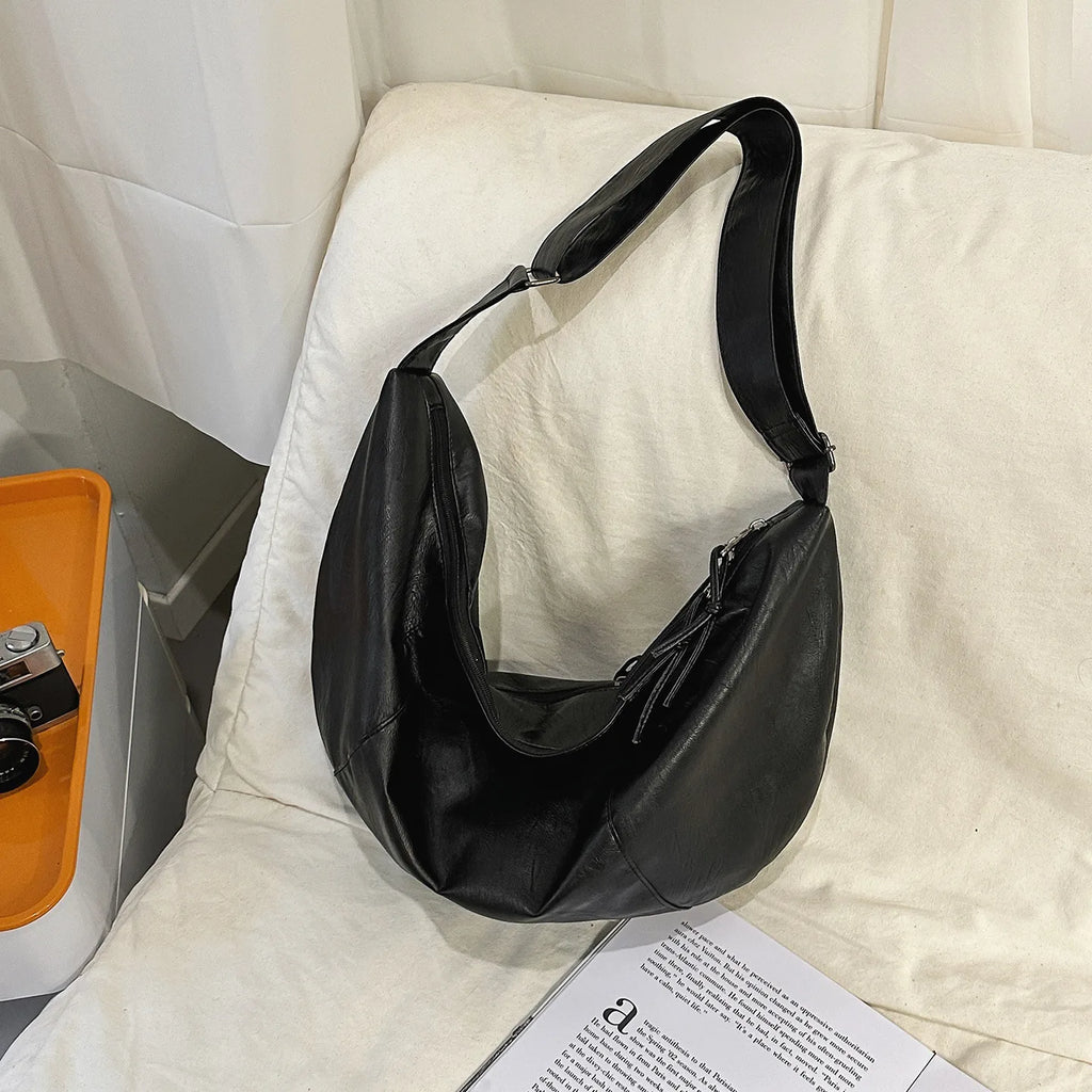 Curved hobo crossbody bag in PU leather – adjustable strap for commuting or riding