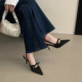Women’s pointed-toe stiletto pumps with a bow and backless heel