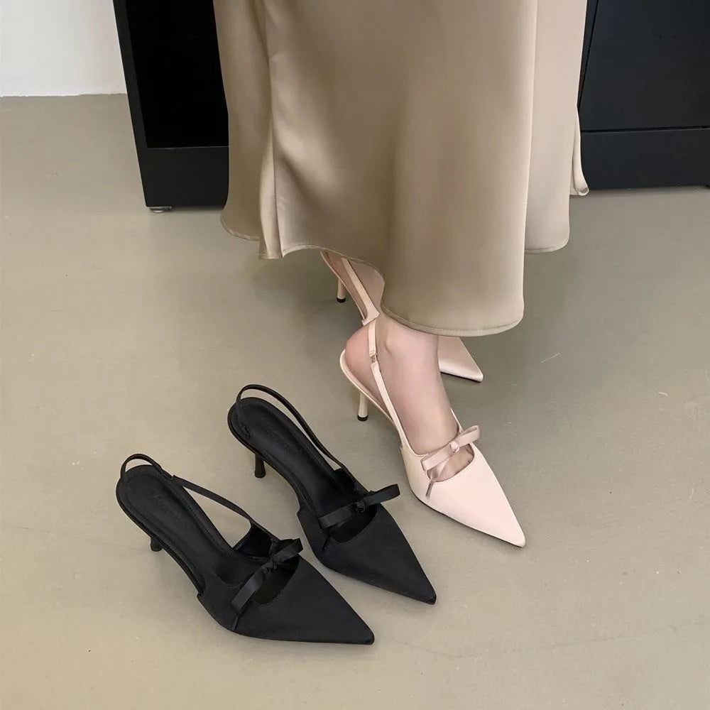 Women’s pointed-toe stiletto pumps with a bow and backless heel