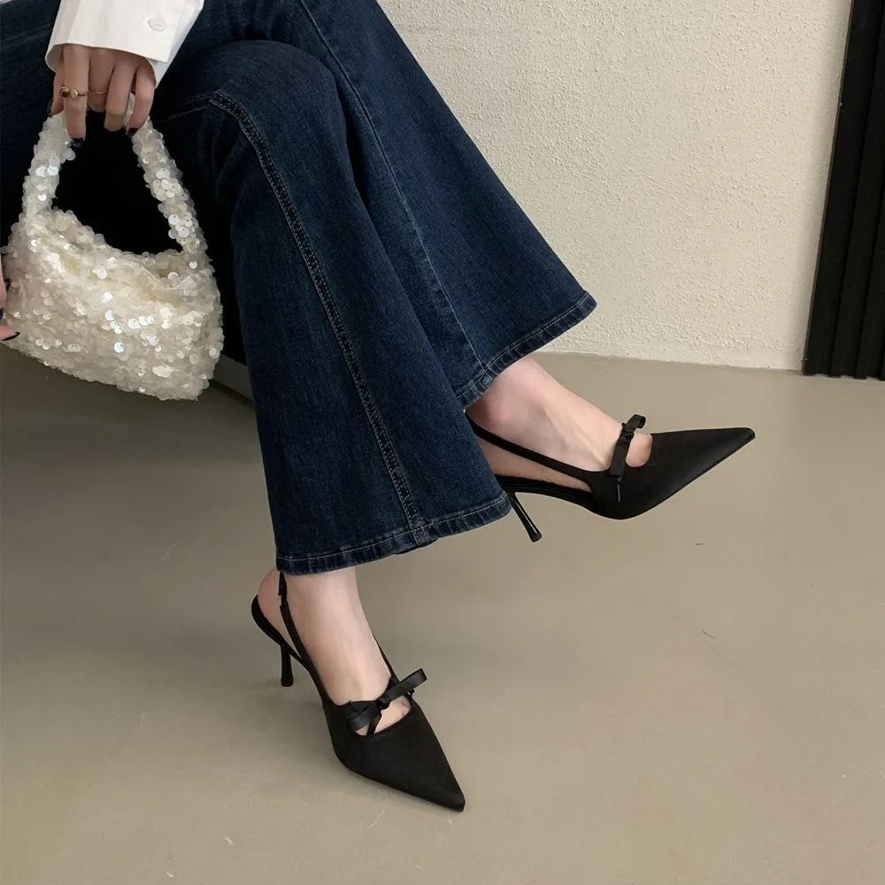 Women’s pointed-toe stiletto pumps with a bow and backless heel