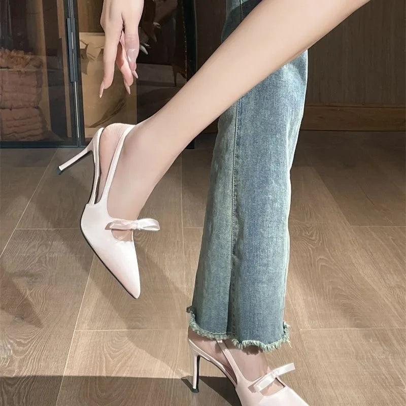 Women’s pointed-toe stiletto pumps with a bow and backless heel