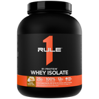Black tub of protein powder with an orange and white label Flavor is Vanilla Butter Cake